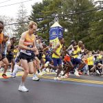 
              The elite men break from the starting line of the 125th Boston Marathon, Monday, Oct. 11, 2021, in Hopkinton, Mass. (AP Photo/Mary Schwalm)
            