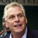 
              FILE - In this May 29, 2021, file photo, Democratic gubernatorial candidate, former Gov. Terry McAuliffe smiles during a tour of downtown Petersburg, Va. McAuliffe won Virginia's 2013 governor's race by embracing his own brand of personal politics that rely on decades-old friendships, back-slapping charisma and tell-it-like-it-is authenticity. (AP Photo/Steve Helber, File)
            