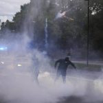 
              Demonstrators run from smoke and a police water cannon during a protest against vaccinations and coronavirus measures in Ljubljana, Slovenia, Tuesday, Oct. 5, 2021. EU leaders are meeting Tuesday evening in nearby Kranj, Slovenia, to discuss increasingly tense relations with China and the security implications of the chaotic U.S.-led exit from Afghanistan, before taking part in a summit with Balkans leaders on Wednesday. (AP Photo/Petr David Josek)
            