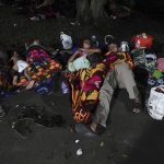
              Migrants, mostly from Central America heading north, sleep on the ground in the Alvaro Obregon community, at Chiapas State, Mexico, Sunday, Oct. 24, 2021. (AP Photo/Marco Ugarte)
            