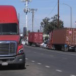 Parked cargo container trucks are seen in a street, Wednesday, Oct. 20, 2021 in Wilmington, Calif. California Gov. Gavin Newsom on Wednesday issued an order that aims to ease bottlenecks at the ports of Los Angeles and Long Beach that have spilled over into neighborhoods where cargo trucks are clogging residential streets. (AP Photo/Ringo H.W. Chiu)