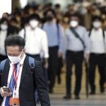 
              Commuters wearing face masks walk in a passageway during a rush hour at Shinagawa Station Friday, Oct. 1, 2021, in Tokyo. Japan lifted its COVID-19 state of emergency in all of the regions on Oct.1. (AP Photo/Eugene Hoshiko)
            