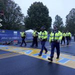 
              Members of the State Police walk across starting line before the start of the 125th Boston Marathon, Monday, Oct. 11, 2021, in Hopkinton, Mass. (AP Photo/Mary Schwalm)
            