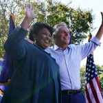 
              FILE - In this Monday, Oct. 17, 2021, file photo, political activist Stacey Abrams, left, waves to the crowd with Democratic gubernatorial candidate, former Virginia Gov. Terry McAuliffe, right, during a rally in Norfolk, Va. McAuliffe won Virginia's 2013 governor's race by embracing his own brand of personal politics that rely on decades-old friendships, back-slapping charisma and tell-it-like-it-is authenticity. (AP Photo/Steve Helber, File)
            