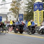 
              Participants in the men's wheelchair division break from the starting line of the 125th Boston Marathon, Monday, Oct. 11, 2021, in Hopkinton, Mass. (AP Photo/Mary Schwalm)
            
