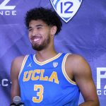 
              FILE - UCLA's Johnny Juzang smiles during Pac-12 Conference NCAA men's college basketball media day in San Francisco, in this Wednesday, Oct. 13, 2021, file photo. UCLA is No. 2 in The Associated Press Top 25 men's college basketball poll, released Monday, Oct. 18, 2021. Leading scorer Johnny Juzang (16.0 ppg) headlines a Bruins roster that returns nearly intact after last year’s run from the First Four to the Final Four, where they lost to Gonzaga on a halfcourt shot in an overtime classic.  (AP Photo/Jeff Chiu, File)
            