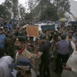 
              Soldiers carry the national flag-wrapped casket of Pakistani nuclear scientist Abdul Qadeer Khan during his funeral prayer, in Islamabad, Pakistan, Sunday, Oct. 10, 2021. Khan, a controversial figure known as the father of Pakistan's nuclear bomb, died Sunday of COVID-19 following a lengthy illness, his family said. He was 85. (AP Photo/Anjum Naveed)
            