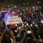 
              People move with an ambulance carrying casket of Pakistani nuclear scientist Abdul Qadeer Khan following a funeral prayer, in Islamabad, Pakistan on Sunday, Oct. 10, 2021. Khan, a controversial figure known as the father of Pakistan's nuclear bomb, died Sunday of COVID-19 following a lengthy illness, his family said. He was 85. (AP Photo/Anjum Naveed)
            