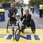 
              Marcel Hug, left, and Manuela Schar, both of Switzerland, pose after winning the wheelchair divisions of the 125th Boston Marathon on Monday, Oct. 11, 2021, in Boston. (AP Photo/Winslow Townson)
            