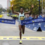 
              Diana Kipyogei, of Kenya, hits the tape to win the women's division of the 125th Boston Marathon on Monday, Oct. 11, 2021, in Boston. (AP Photo/Winslow Townson)
            