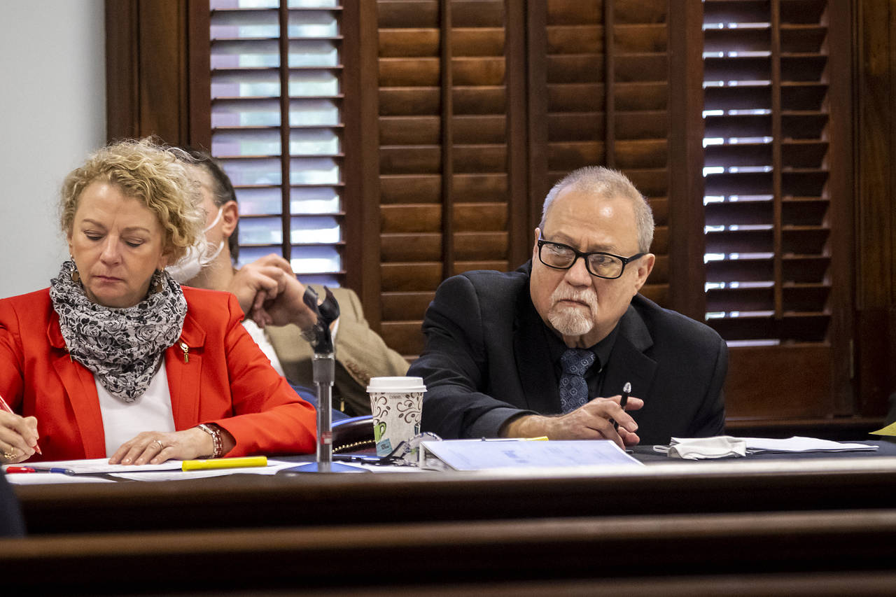 FILE - Greg McMichael, right, listens to attorneys question a pool of prospective jurors during jur...