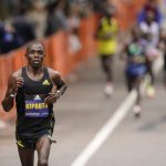 
              Benson Kipruto, of Kenya, runs ahead of an elite group of runners during the 125th Boston Marathon, Monday, Oct. 11, 2021, in Brookline, Mass. Kipruto won the men's division of the marathon. (AP Photo/Steven Senne)
            
