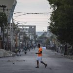 
              A man walks through a street empty of traffic due to a general strike in Port-au-Prince, Haiti, Monday, Oct. 18, 2021. Workers angry about the nation's lack of security went on strike in protest two days after 17 members of a US-based missionary group were abducted by a violent gang. (AP Photo/Joseph Odelyn)
            
