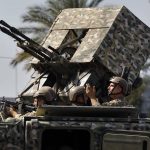 
              Lebanese army soldiers on a vehicle react to gunfire during armed clashes that erupted during a protest in the southern Beirut suburb of Dahiyeh, Lebanon, Thursday, Oct. 14, 2021. Armed clashes broke out in Beirut Thursday during a protest against the lead judge investigating last year's massive blast in the city's port, as tensions over the domestic probe boiled over. (AP Photo/Bilal Hussein)
            