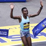 
              Diana Kipyogei, of Kenya, celebrates at the finish line after winning the women's division of the Boston Marathon in Boston, Monday, Oct. 11, 2021. (AP Photo/Charles Krupa)
            