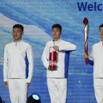
              Volunteers hold the Olympic torch and the frame on stage during a welcome ceremony for the Frame of Olympic Winter Games Beijing 2022, held at the Olympic Tower in Beijing, Wednesday, Oct. 20, 2021. A welcome ceremony for the Olympic flame was held in Beijing on Wednesday morning after it arrived at the Chinese capital from Greece. While the flame will be put on display over the next few months, organizers said a three-day torch relay is scheduled starting February 2nd with around 1200 torchbearers in Beijing, Yanqing and Zhangjiakou. (AP Photo/Andy Wong)
            