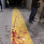 
              Supporters of a Shiite group allied with Hezbollah stand next to blood from an injured comrade during armed clashes that erupted during a protest in the southern Beirut suburb of Dahiyeh, Lebanon, Thursday, Oct. 14, 2021. It was not immediately clear what triggered the gunfire, but tensions were high along a former civil war front-line between Muslim Shiite and Christian areas. (AP Photo/Hassan Ammar)
            