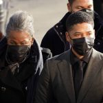 Actor Jussie Smollett arrives with his mother Janet, Tuesday, Nov. 30, 2021, at the Leighton Criminal Courthouse for day two of his trial in Chicago. Smollett is accused of lying to police when he reported he was the victim of a racist, anti-gay attack in downtown Chicago nearly three years ago. (AP Photo/Charles Rex Arbogast)