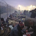 
              Migrants from the Middle East and elsewhere gather at the checkpoint "Kuznitsa" at the Belarus-Poland border near Grodno, Belarus, on Monday, Nov. 15, 2021. The EU is calling for humanitarian aid as up to 4,000 migrants are stuck in makeshift camps in freezing weather in Belarus while Poland has reinforced its border with 15,000 soldiers, in addition to border guards and police. (Leonid Shcheglov/BelTA via AP)
            