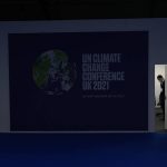 
              A man stands inside a room at the venue of the COP26 U.N. Climate Summit in Glasgow, Scotland, Friday, Nov. 12, 2021. Negotiators from almost 200 nations were making a fresh push Friday to reach agreements on a series of key issues that would allow them to call this year's U.N. climate talks a success. (AP Photo/Alastair Grant)
            