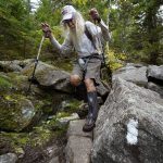 
              M.J. Eberhart, 83, carefully makes his way through large rocks while descending Mount Hayes on the Appalachian Trail, Sunday, Sept. 12, 2021, in Gorham, New Hampshire. Eberhart, who goes by the trail name of Nimblewill Nomad, is the oldest person to hike the entire 2,193-mile Appalachian Trail. (AP Photo/Robert F. Bukaty)
            