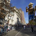 
              People watch as the Smokey Bear balloon passes during the Macy's Thanksgiving Day Parade in New York, Thursday, Nov. 25, 2021. The parade is returning in full, after being crimped by the coronavirus pandemic last year. (AP Photo/Seth Wenig)
            