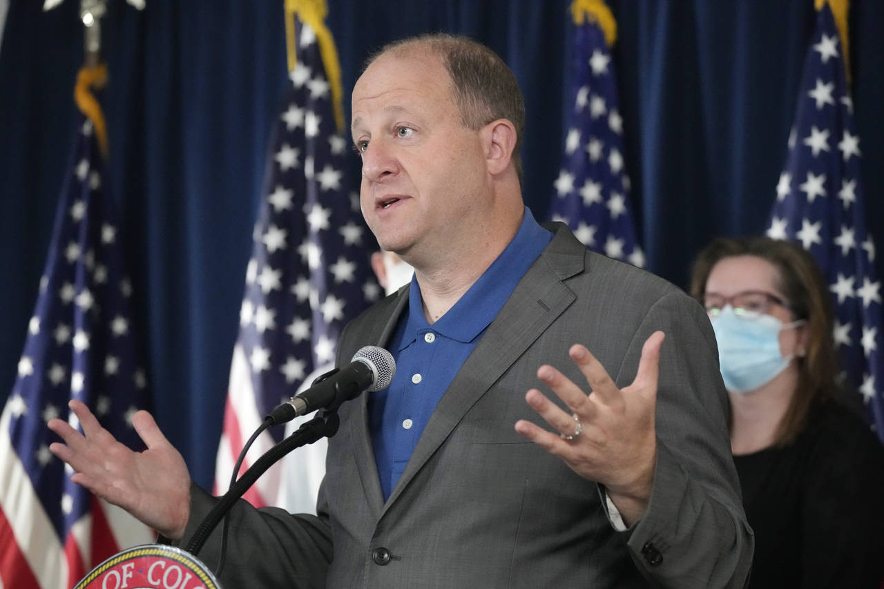 FILE - Colorado Gov. Jared Polis speaks during a news conference about Colorado offering coronaviru...