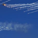 
              An Emirati fighter jet flies through smoke after releasing chaff during a stunt at the Dubai Air Show in Dubai, United Arab Emirates, Sunday, Nov. 14, 2021. The biennial Dubai Air Show opened Sunday as commercial aviation tries to shake off the coronavirus pandemic. (AP Photo/Jon Gambrell)
            