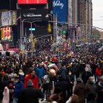 
              People make their way at Times Square after the Macy's Thanksgiving Day Parade, Thursday, Nov. 25, 2021, in New York. AP Photo/Eduardo Munoz Alvarez)
            