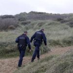 
              French police officer patrol on the dunes in Wimereux, northern France, Thursday, Nov. 25, 2021 in Calais, northern France. Children and pregnant women were among at least 27 migrants who died when their small boat sank in an attempted crossing of the English Channel, a French government official said Thursday. French Interior Minister Gerald Darmanin also announced the arrest of a fifth suspected smuggler thought to have been involved in what was the deadliest migration tragedy to date on the dangerous sea lane.(AP Photo/Michel Spingler)
            