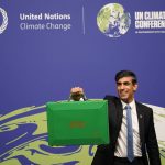 
              Britain's Chancellor of the Exchequer Rishi Sunak holds up a Green briefcase as he arrives for a speech at the COP26 U.N. Climate Summit in Glasgow, Scotland, Wednesday, Nov. 3, 2021. The British government plans to make the U.K. "the world's first net-zero aligned financial center" as companies and investors seek to profit from the drive to build a low-carbon economy. Sunak will lay out the government's plans during a speech Wednesday as top financial officials from around the world meet at the U.N. climate conference in Glasgow, Scotland. (AP Photo/Alberto Pezzali)
            