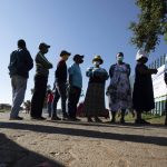 
              People queue outside a polling station in Thokoza, east of Johannesburg, Monday, Nov. 1, 2021. South Africa is holding crucial local elections Monday. (AP Photo/Themba Hadebe)
            