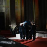
              Six carriers of the Air Force and Space carry the cenotaph of Josephine Baker, covered with the French flag, into the Pantheon in Paris, France, Tuesday, Nov. 30, 2021, where she is to symbolically be inducted, becoming the first Black woman to receive France's highest honor. Her body will stay in Monaco at the request of her family. (Thibault Camus/Pool Photo via AP)
            