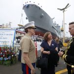 USMC Colonel Alison Thompson, left, talks with Jenn Onofrio, center, a White House Fellow to the Secretary of the Navy and Patrik Gallineaux, right, of the Richmond/Ermet Aid Foundation prior to the launching of the USNS Harvey Milk, a fleet replenishment oiler ship named after the first openly gay elected official, Saturday, Nov. 6, 2021 in San Diego.  The Navy ship is the second of six vessels in the Navy's John Lewis-class program, second to the USNS John Lewis. (AP Photo/Alex Gallardo)