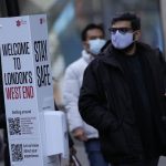 
              Bus passengers wait at a bus stop next to a Stay Safe sign which encourages social distancing and the wearing of masks to curb the spread of COVID-19, in London, Tuesday, Nov. 30, 2021. The emergence of the new COVID-19 omicron variant and the world's desperate and likely futile attempts to keep it at bay are reminders of what scientists have warned for months: The coronavirus will thrive as long as vast parts of the world lack vaccines.(AP Photo/Alastair Grant)
            