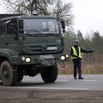 
              A polish army vehicle drives past a check point close to the border with Belarus in Kuznica, Poland, Tuesday, Nov. 16, 2021. (AP Photo/Matthias Schrader)
            
