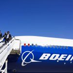 
              Boeing staffers come off a Boeing 777X on display at the Dubai Air Show in Dubai, United Arab Emirates, Sunday, Nov. 14, 2021. The biennial Dubai Air Show opened Sunday as commercial aviation tries to shake off the coronavirus pandemic. (AP Photo/Jon Gambrell)
            