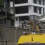 
              Rescue workers search for survivors in the rubble of the collapsed 21-story apartment building under construction in Lagos, Nigeria, Tuesday, Nov. 2, 2021. Authorities in Nigeria's largest city say the owner of a high-rise apartment building that collapsed suddenly has been arrested. The news came Tuesday as officials announced that 14 people had been confirmed dead following Monday's accident. Dozens of others are believed to still be trapped in the rubble of the 21-story building that was under construction in the Ikoyi area of Lagos. (AP Photo/Sunday Alamba)
            