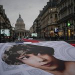 
              Pictures of Josephine Baker and a red carpet lead to the Pantheon monument, rear, in Paris, France, Tuesday, Nov. 30, 2021 , where Baker is to symbolically be inducted, becoming the first Black woman to receive France's highest honor. A coffin carrying soils from the U.S., France and Monaco will be deposited inside the Pantheon. Her body will stay in Monaco at the request of her family. (AP Photo/Christophe Ena)
            