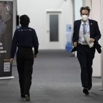 
              Luxembourg negotiator Andrew Ferrone runs inside the venue of the COP26 U.N. Climate Summit in Glasgow, Scotland, Friday, Nov. 12, 2021. Negotiators from almost 200 nations were making a fresh push Friday to reach agreements on a series of key issues that would allow them to call this year's U.N. climate talks a success. (AP Photo/Alastair Grant)
            