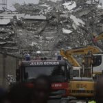 
              A view of the rubble of the collapsed 21-story apartment building under construction in Lagos, Nigeria, Tuesday, Nov. 2, 2021. Authorities in Nigeria's largest city say the owner of a high-rise apartment building that collapsed suddenly has been arrested. The news came Tuesday as officials announced that 14 people had been confirmed dead following Monday's accident. Dozens of others are believed to still be trapped in the rubble of the 21-story building that was under construction in the Ikoyi area of Lagos. (AP Photo/Sunday Alamba)
            