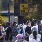 
              Dozens of onlookers gathered at the scene where rapper Young Dolph was killed at a cookie shop in Memphis, Tenn., Wednesday, Nov. 17, 2021. Young Dolph, widely admired in the hip-hop community for his authenticity and fierce independence, was shot and killed Wednesday in his hometown of Memphis, Tenn., authorities said. (Patrick Lantrip/Daily Memphian via AP)
            