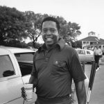 
              FILE - Lee Elder is seen arriving at the Masters golf course to play practice round in Augusta, Ga., on April 10, 1975. Elder broke down racial barriers as the first Black golfer to play in the Masters and paved the way for Tiger Woods and others to follow. The PGA Tour confirmed Elder’s death, which was first reported by Debert Cook of African American Golfers Digest. No cause or details were immediately available, but the tour said it spoke with Elder's family. He was 87. (AP Photo/File)
            