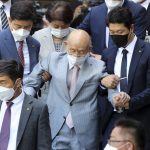 
              Former South Korean President Chun Doo-hwan, center, leaves a district court after attending an appellate trial on the charge of libel in Gwangju, South Korea, on Aug. 9, 2021. Former South Korean military strongman Chun, who crushed pro-democracy demonstrations in 1980, has died on Tuesday, Nov. 23, 2021. He was 90. (Yonhap via AP)
            