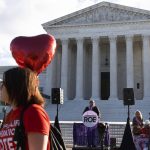 
              Anti-abortion activists rally outside the Supreme Court, Monday, Nov. 1, 2021, as arguments are set to begin about abortion by the court, on Capitol Hill in Washington. (AP Photo/Jacquelyn Martin)
            