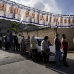
              Voters line up outside a polling station during general elections in Tegucigalpa, Honduras, Sunday, Nov. 28, 2021. (AP Photo/Moises Castillo)
            