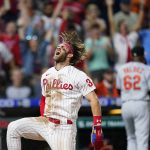 
              FILE - Philadelphia Phillies' Bryce Harper celebrates after scoring the game-winning run on a two-run triple by J.T. Realmuto during the 10th inning of an interleague baseball game against the Baltimore Orioles, Tuesday, Sept. 21, 2021, in Philadelphia. On Thursday, Nov. 18, 2021, Harper earned the National League MVP honor for the second time. (AP Photo/Matt Slocum, File)
            