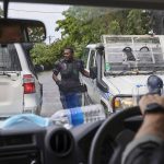 
              Australian Federal Police drive through the streets of Honiara, Solomon Islands, Monday, Dec. 6, 2021. Lawmakers in the Solomon Islands are debating whether they still have confidence in the prime minister, after rioters last month set fire to buildings and looted stores in the capital. (Gary Ramage via AP)
            