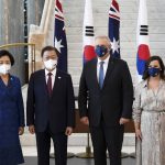 
              South Korean President Moon Jae-in, second left, and his wife, Kim Jung-sook, left, pose for a photo with Australian Prime Minister Scott Morrison and his wife, Jenny, right, at Parliament House, in Canberra, Australia, Monday, Dec. 13, 2021. Moon is on a two-day official visit to Australia. (Lukas Coch/Pool Photo via AP)
            