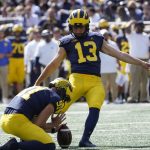 
              FILE - Michigan placekicker Jake Moody kicks an extra point in the second half of an NCAA college football game in Ann Arbor, Mich., Sept. 18, 2021. (AP Photo/Paul Sancya)
            